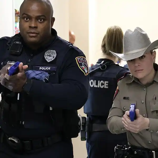 two officers practicing active shooter response techniques